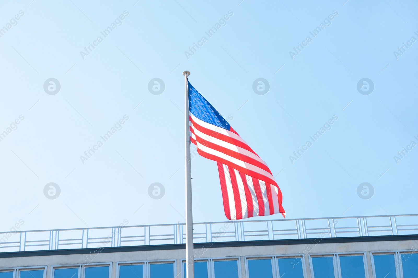 Photo of American flag fluttering outdoors on sunny day