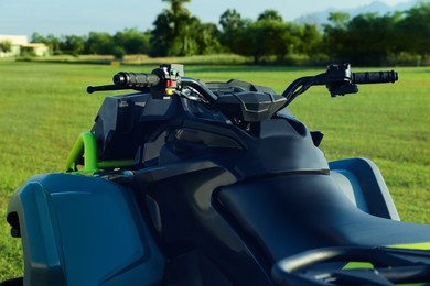 Modern quad bike in field on sunny day, closeup