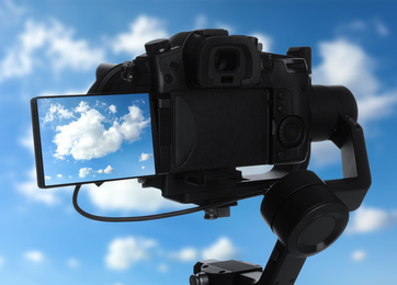 Image of Recording beautiful view of sky with clouds on professional video camera