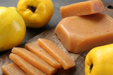 Tasty sweet quince paste and fresh fruits on grey table, closeup
