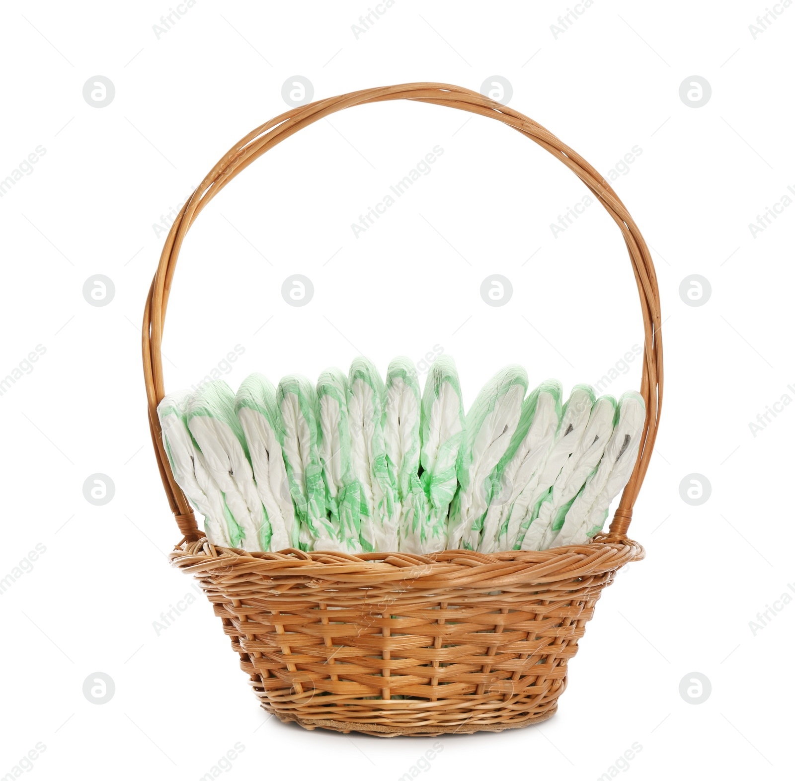 Photo of Wicker basket with disposable diapers on white background. Baby accessories