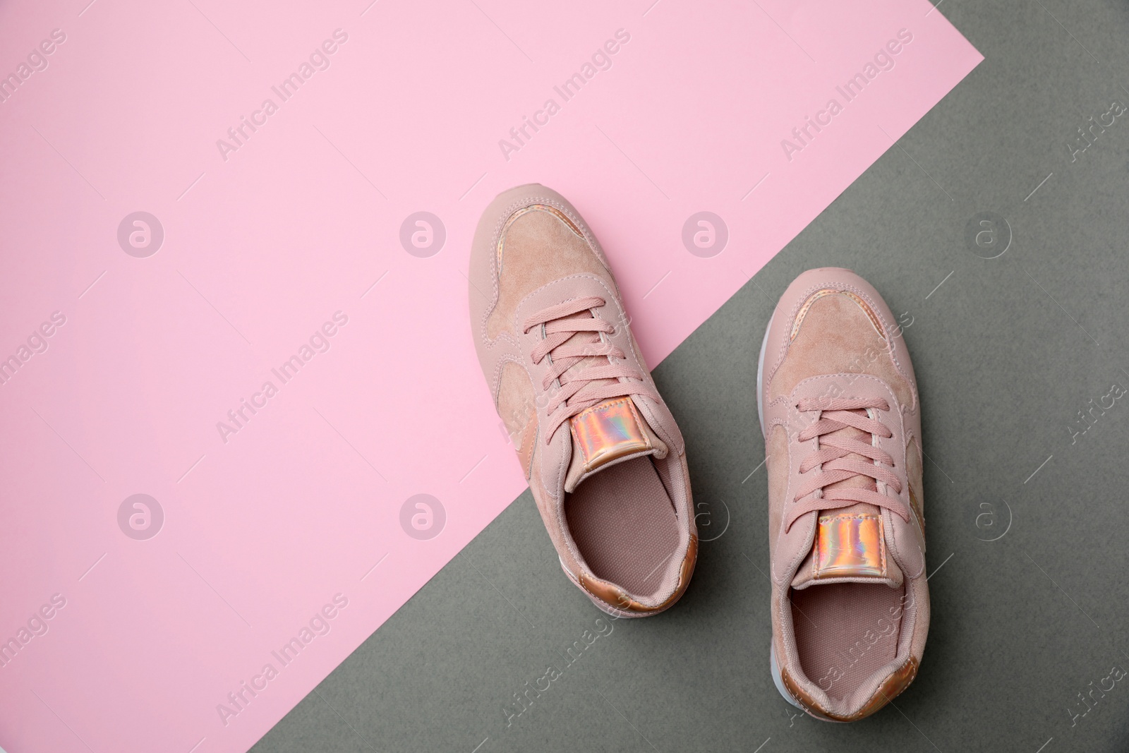 Photo of Stylish women's sneakers on color background, top view. Space for text