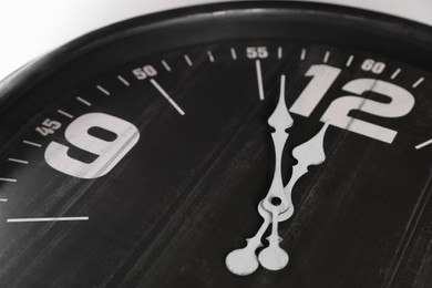Photo of Stylish analog clock on white background, closeup. New Year countdown