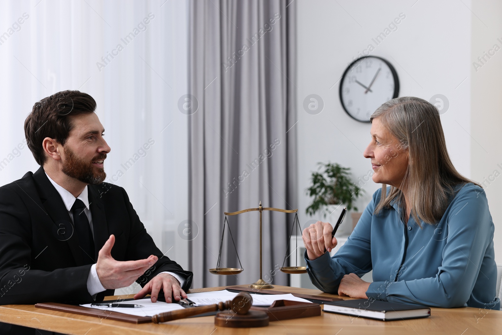 Photo of Senior woman having meeting with lawyer in office