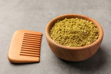 Henna powder and comb on light grey background, closeup. Natural hair coloring