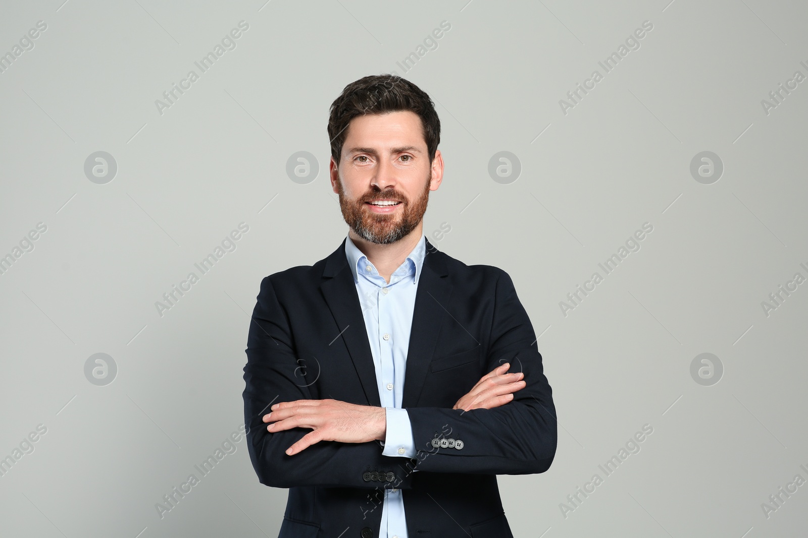 Photo of Handsome real estate agent in nice suit on grey background