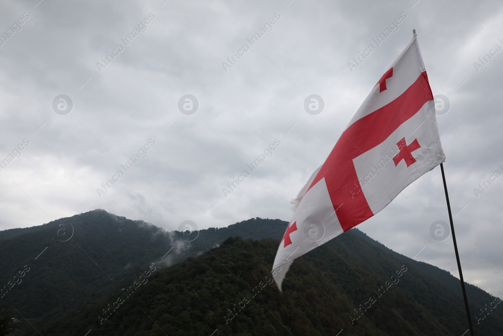 Photo of Adjara, Georgia – September 4, 2002: Georgian flag on Gvara Fortress in mountains