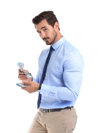 Handsome businessman counting money on white background