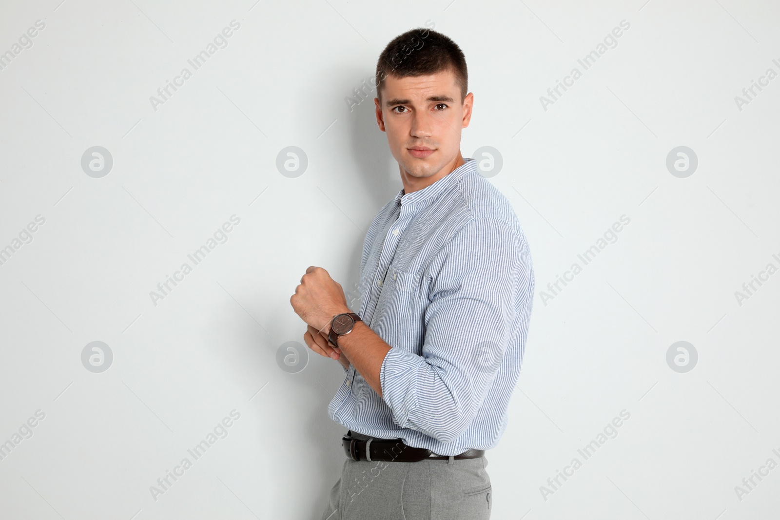 Photo of Portrait of handsome young man on light background