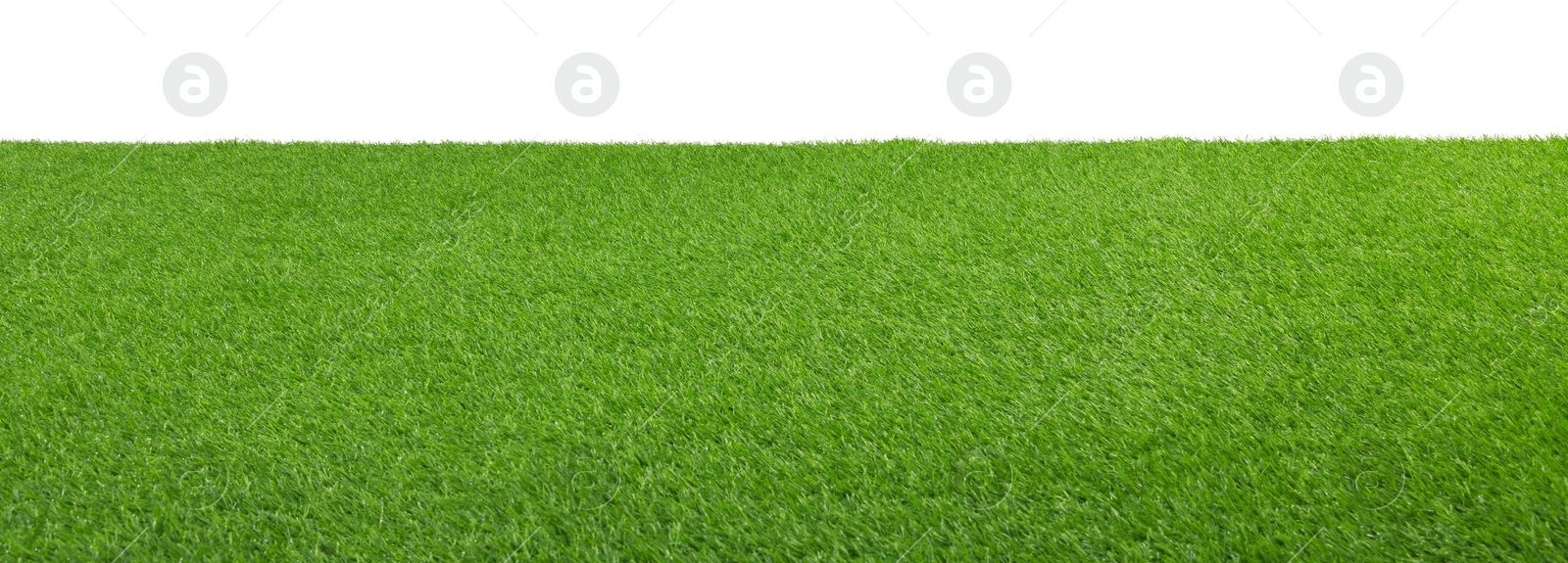 Photo of Green artificial grass surface isolated on white