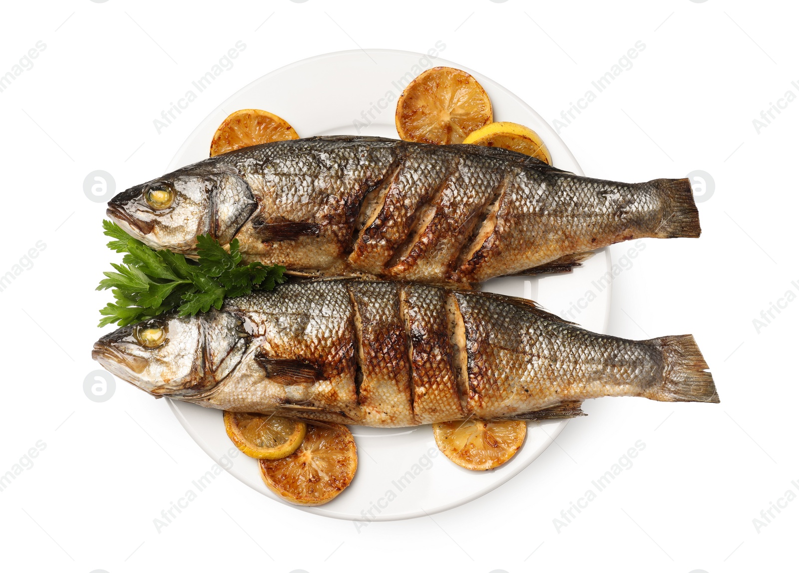 Photo of Plate with delicious sea bass fish, lemon and parsley isolated on white