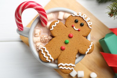 Tasty homemade Christmas cookie and hot chocolate with marshmallows on white wooden table, top view