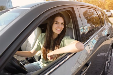 Photo of Beautiful young woman driving car on sunny day