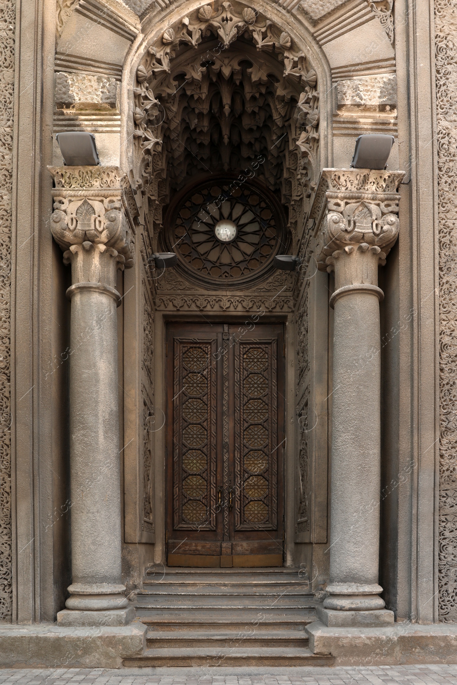 Photo of Beautiful old building with arch and ornate door