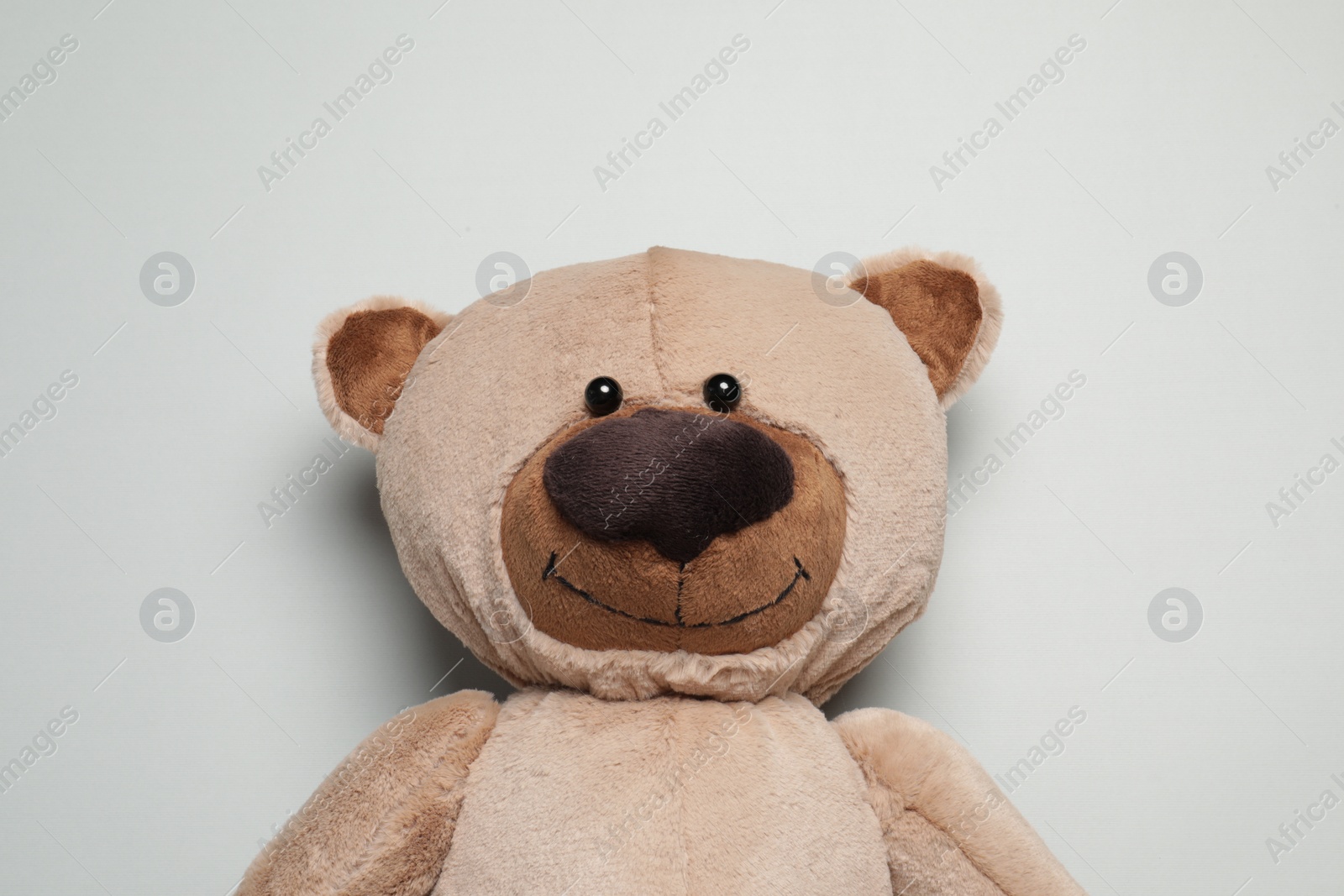 Photo of Cute teddy bear on light grey background, top view