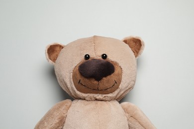 Cute teddy bear on light grey background, top view