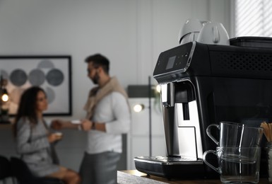 Photo of Modern coffee machine in office. Space for text