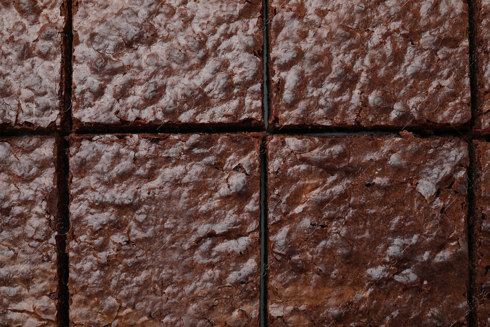 Photo of Closeup of delicious chocolate brownie as background, top view