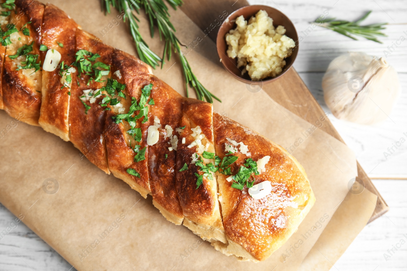 Photo of Delicious homemade garlic bread on table, top view