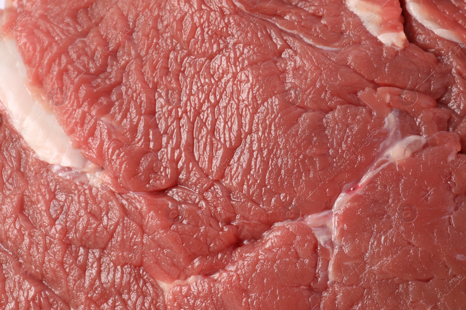 Photo of Piece of raw beef meat as background, closeup