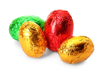 Chocolate eggs wrapped in bright foil on white background