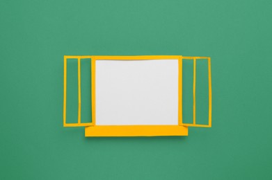 Open paper window frame on green background. Space for text