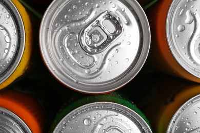 Photo of Energy drinks in wet cans, top view. Functional beverage