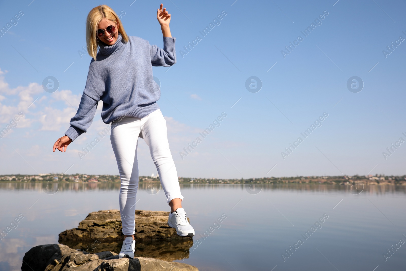 Photo of Happy woman in stylish sweater on beach