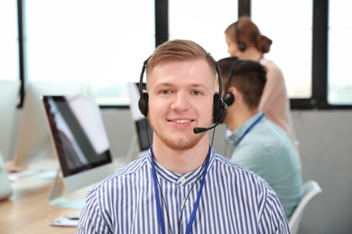 Technical support operator with colleagues in office