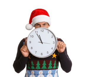 Photo of Man in Santa hat with clock on white background. New Year countdown