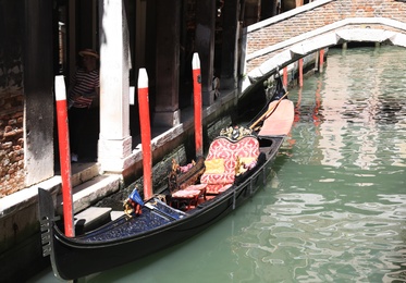 Photo of VENICE, ITALY - JUNE 13, 2019: Gondola on city canal. Gondola is traditional Venetian rowing boat