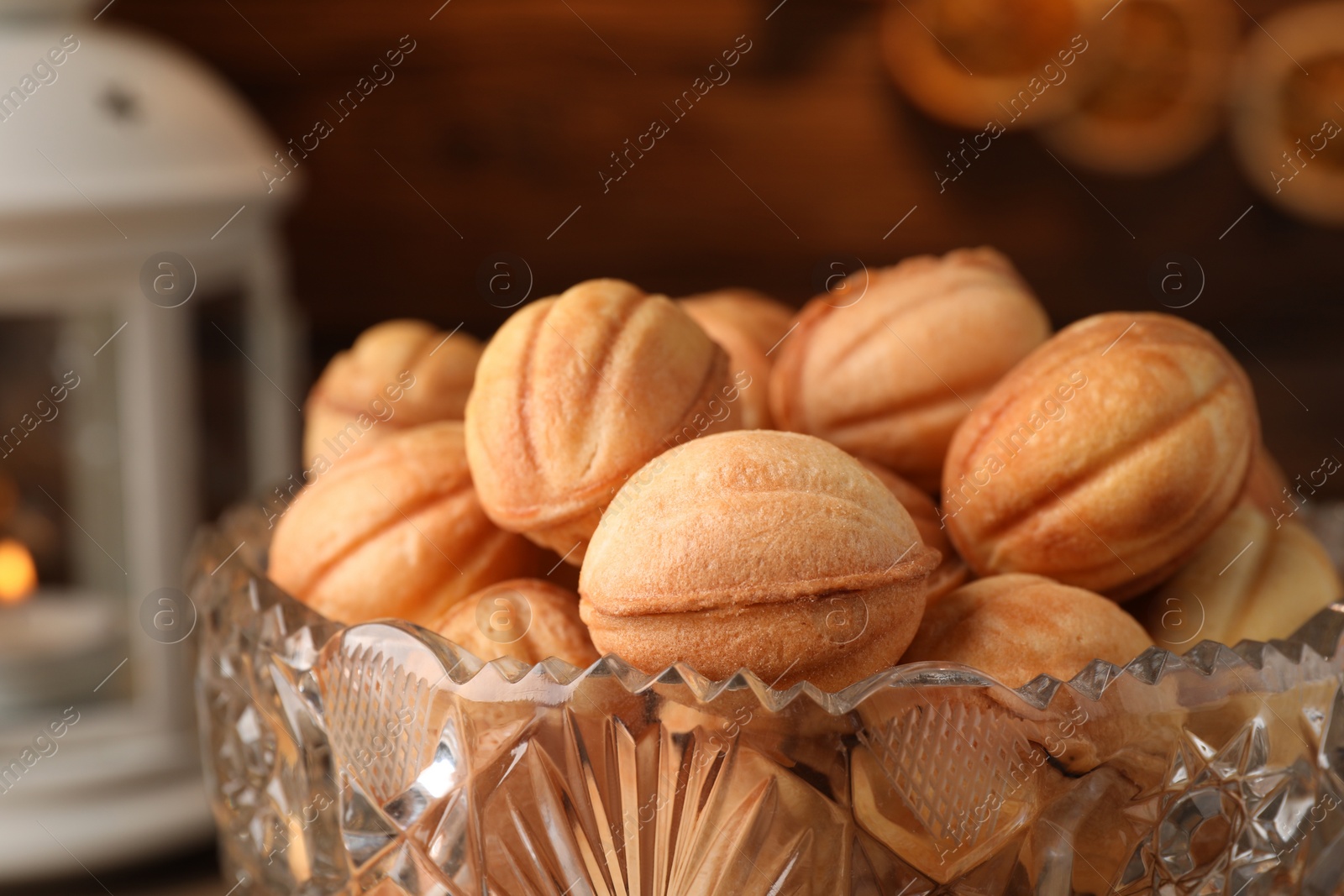 Photo of Bowl of delicious nut shaped cookies on table, closeup