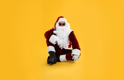 Santa Claus with sunglasses on yellow background