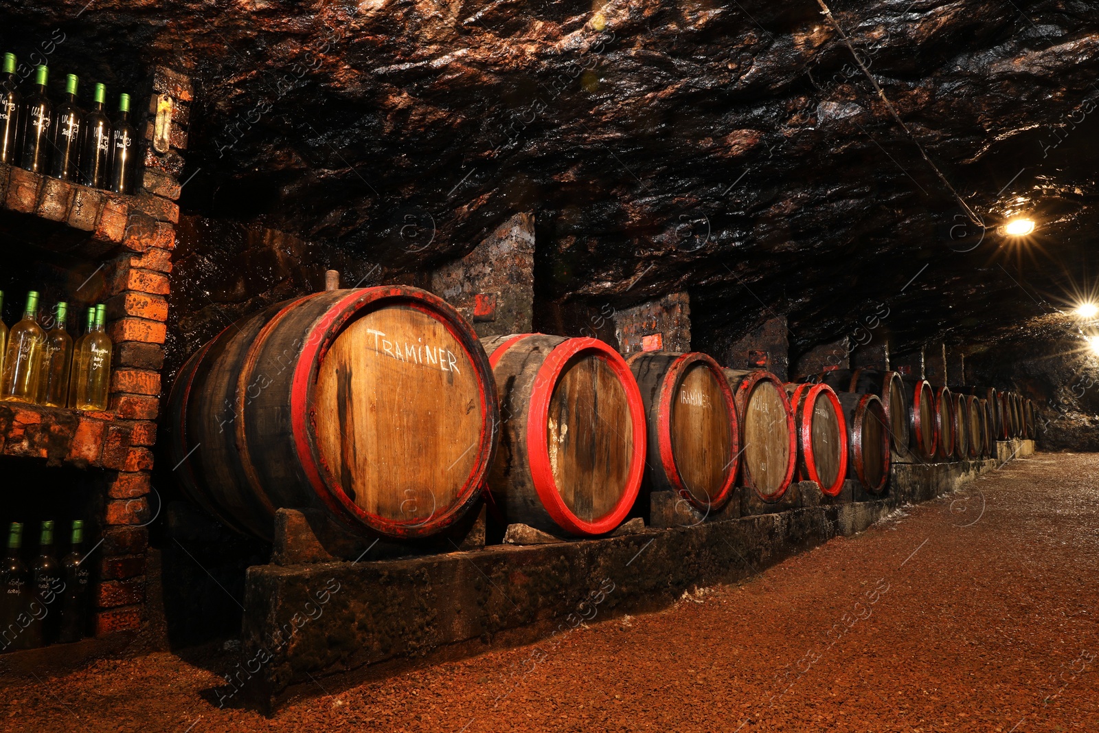 Photo of Bene, Ukraine - June 23, 2023: Many wooden barrels with alcohol drinks in cellar
