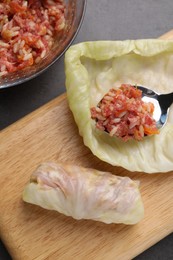Photo of Preparing stuffed cabbage rolls on grey table, flat lay