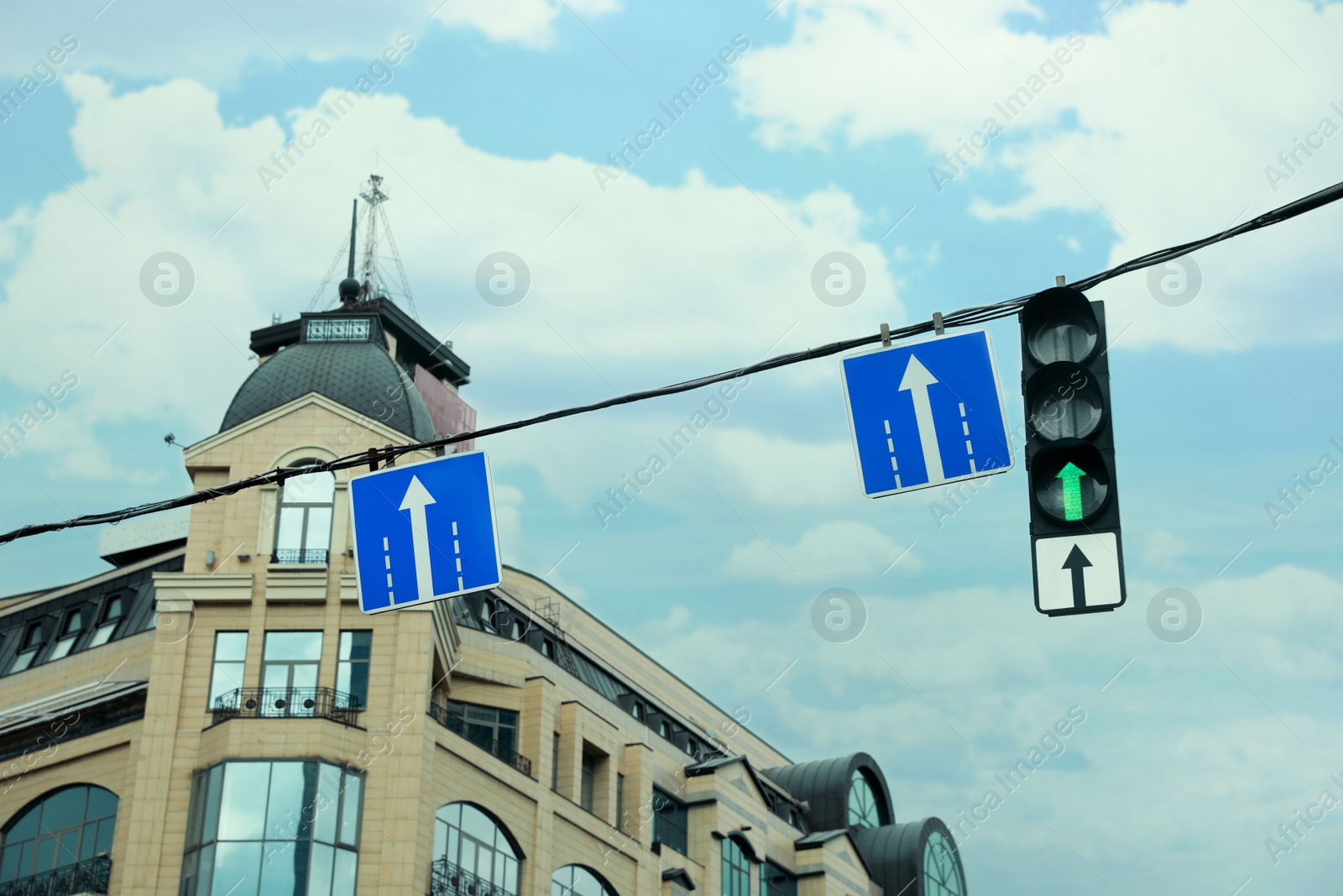 Photo of City street with traffic lights and road signs