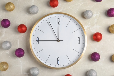 Photo of Flat lay composition with clock on light background. Christmas countdown