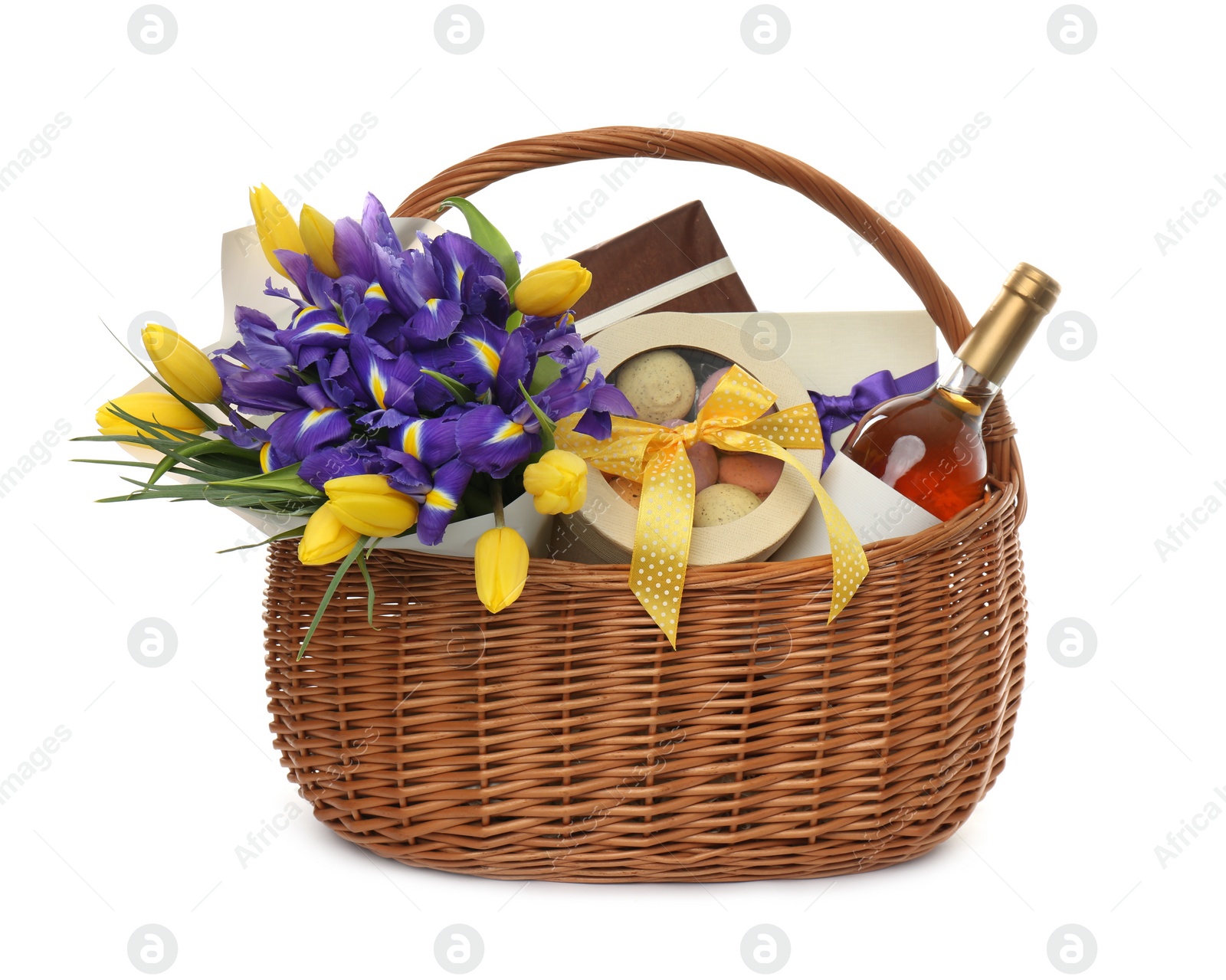 Photo of Wicker basket with gift, bouquet and wine on white background