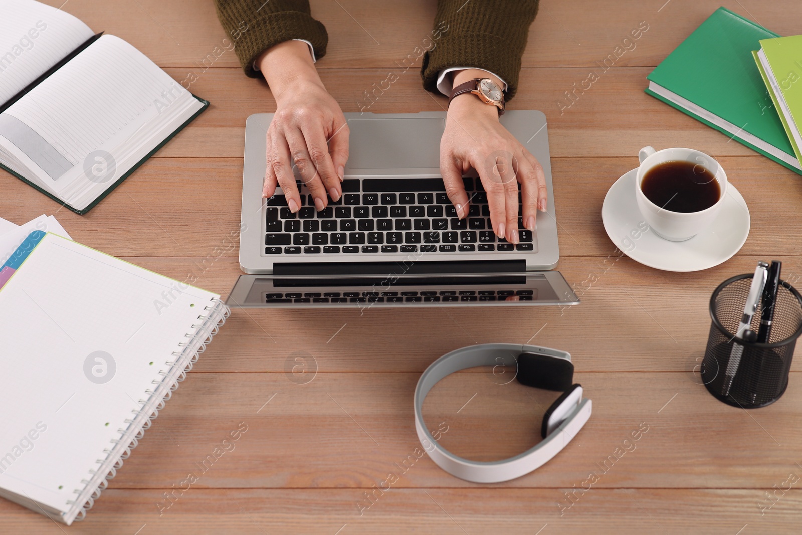 Photo of Woman with modern laptop learning at table, closeup