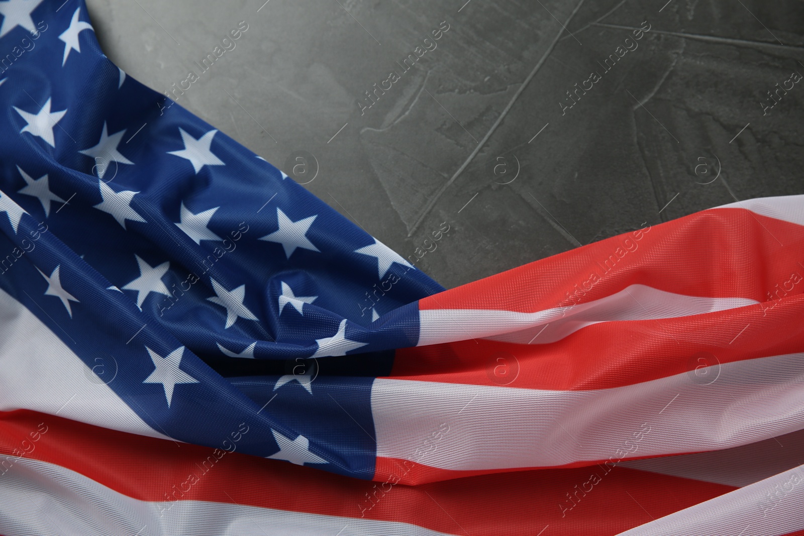 Photo of Flag of USA on black table, top view. Space for text