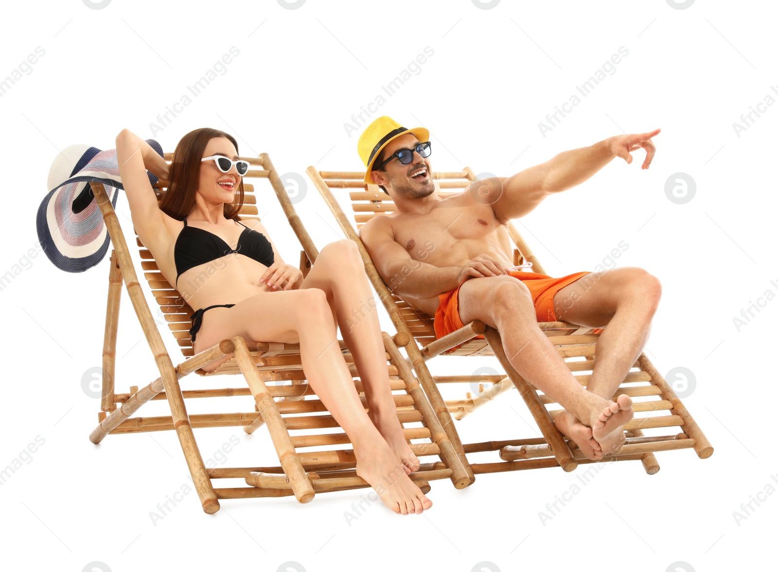 Photo of Young couple on sun loungers against white background. Beach accessories