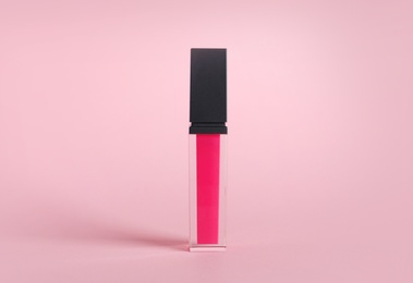 Photo of Beautiful liquid lipstick on color background. Decorative cosmetics