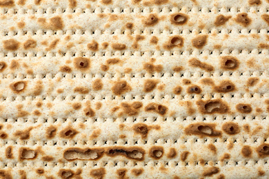 Photo of Traditional Matzo as background, top view. Pesach (Passover) celebration