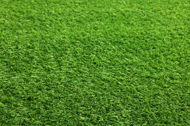 Photo of Green artificial grass as background, closeup view