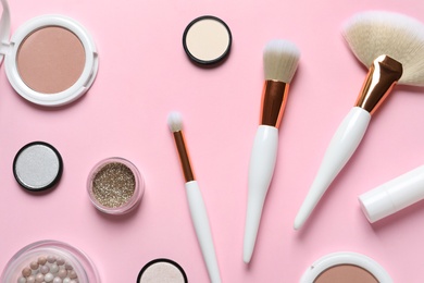 Photo of Flat lay composition with makeup brushes on pink background