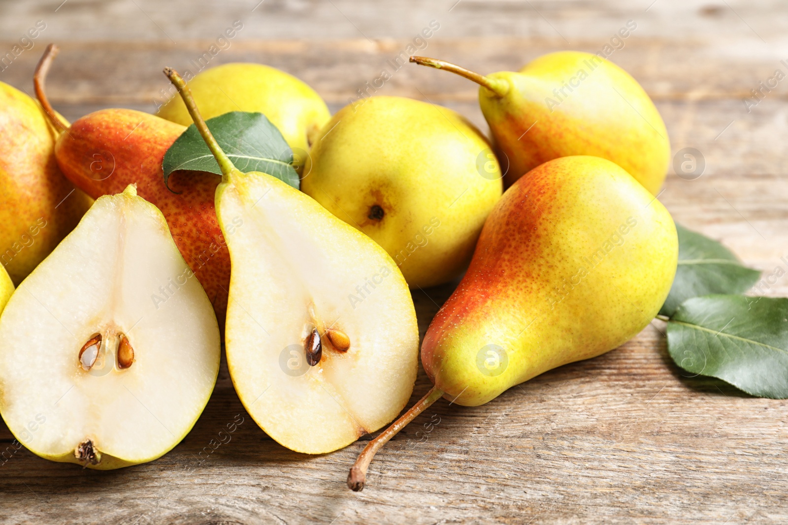 Photo of Ripe pears on wooden table. Healthy snack