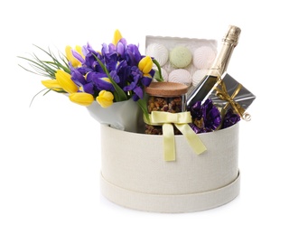 Basket with gifts, bouquet and champagne on white background