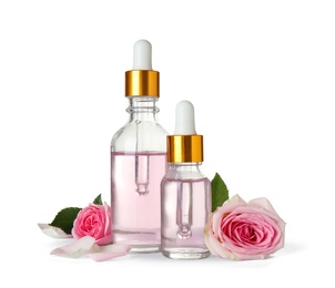 Photo of Bottles of essential oil and roses on white background