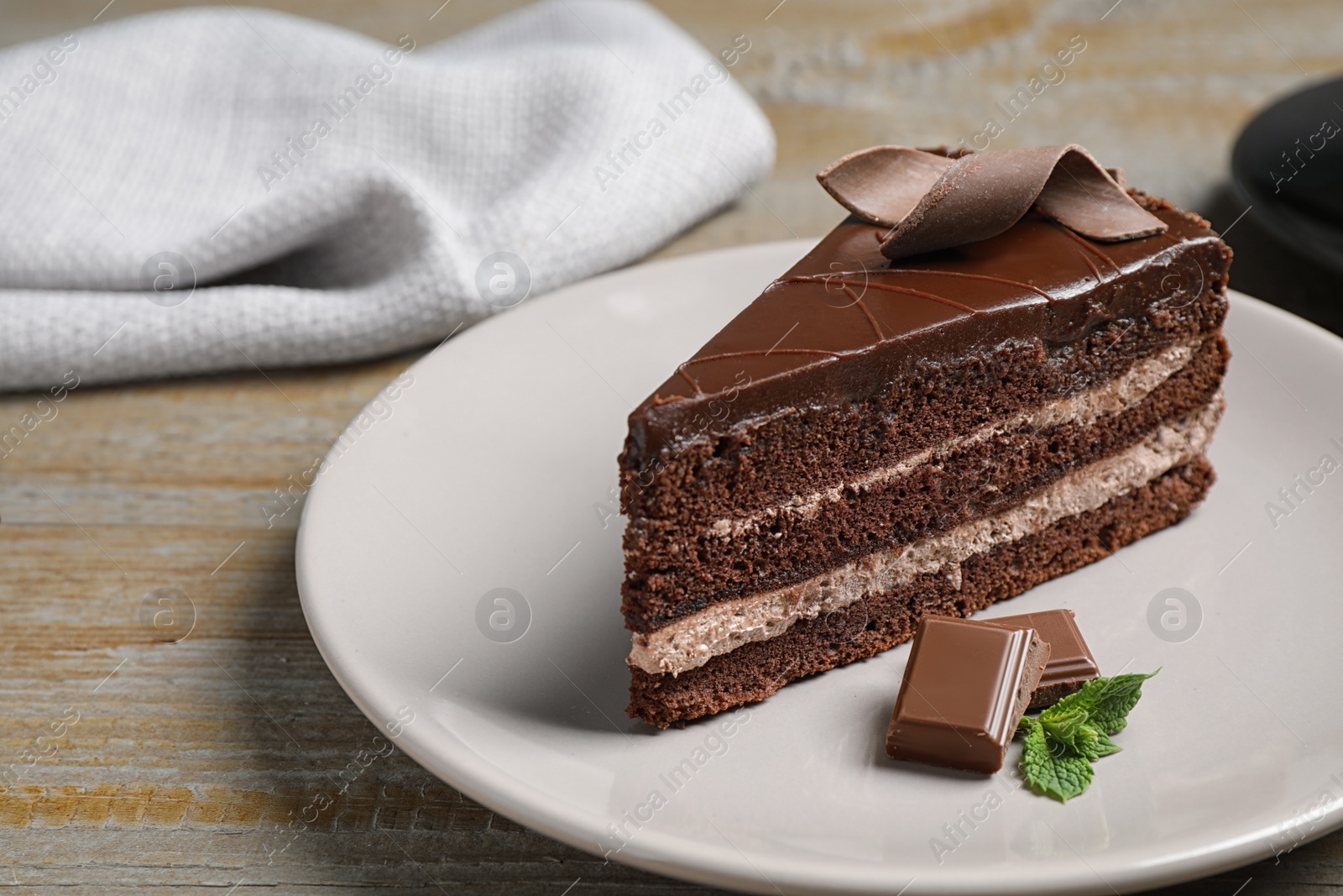 Photo of Delicious fresh chocolate cake served on wooden table