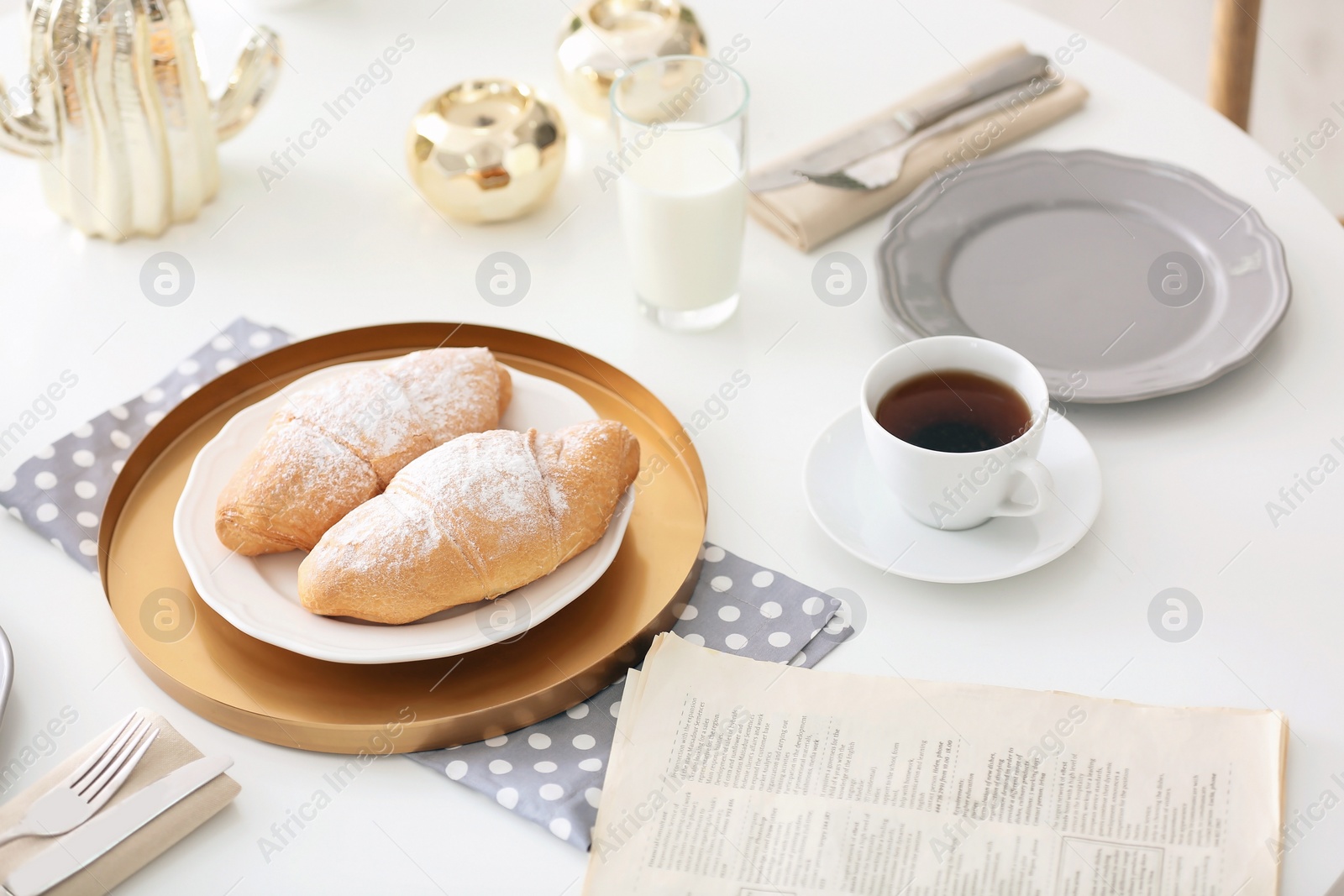 Photo of Tasty breakfast with fresh croissants and cup of coffee on table